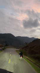 Motorcyclist travels mountain road in Mù Cang Chải, Vietnam