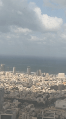 Coastal cityscape with high-rise buildings filmed from elevated position