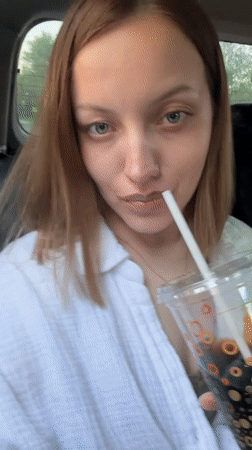 Woman travels through Reshetnikovo, drinks and applies skincare