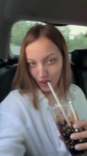 Woman travels through Reshetnikovo, drinks and applies skincare