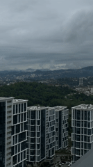 Aerial view captures Sochi high-rises against mountainous backdrop