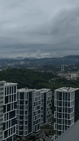 Aerial view captures Sochi high-rises against mountainous backdrop