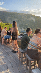 Sunset gathering at tropical beachfront resort with pools and performances