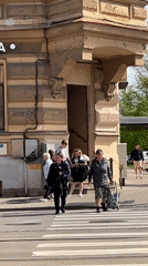 Woman with white chrysanthemums observed at Saint Petersburg crosswalk