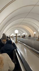 Morning commute captured at ornate Moscow metro station
