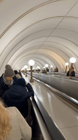 Morning commute captured at ornate Moscow metro station