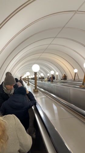 Morning commute captured at ornate Moscow metro station