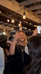 Woman balances beer bottle on head at San Diego bar