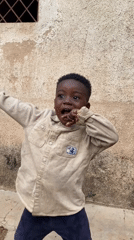 Child plays outside building in Vom, Nigeria