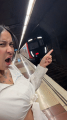 Woman boards Barcelona subway, makes playful gesture inside train