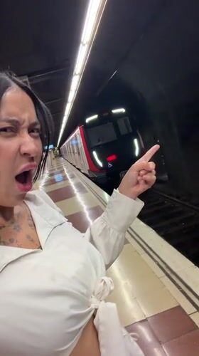 Woman boards Barcelona subway, makes playful gesture inside train