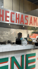 Food worker serves customer at Mexico City tortilla stand