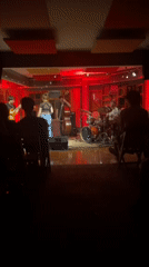 Woman performs on dimly lit stage in Buenos Aires