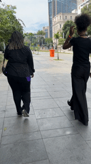 Two pedestrians walk along Rio de Janeiro walkway