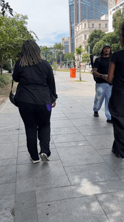 Two pedestrians walk along Rio de Janeiro walkway
