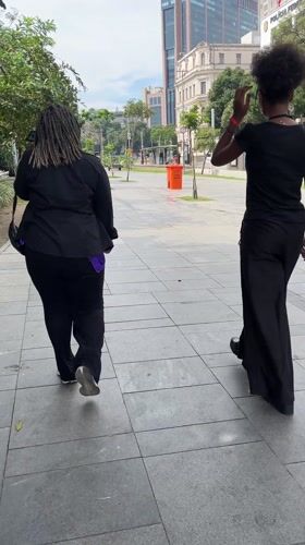 Two pedestrians walk along Rio de Janeiro walkway