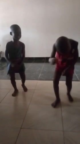 Children dancing, woman resting at home in Goni Gara