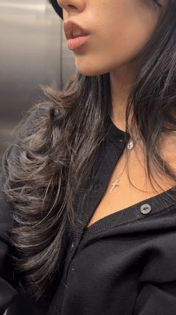 Woman shows surprise in elevator, Rosario Argentina