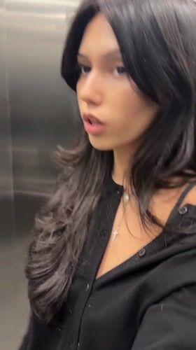Woman shows surprise in elevator, Rosario Argentina