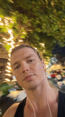 Man records selfie video outdoors in Kuta at night