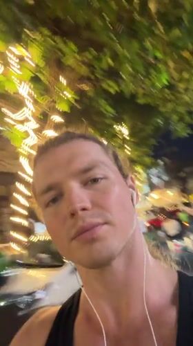 Man records selfie video outdoors in Kuta at night