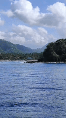Motorboats travel coastal waters off Karangasem, Indonesia