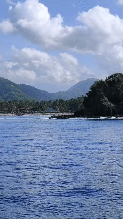 Motorboats travel coastal waters off Karangasem, Indonesia
