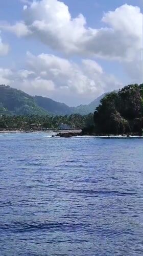 Motorboats travel coastal waters off Karangasem, Indonesia