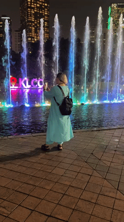 Crowds gather for nighttime fountain show at KLCC Park