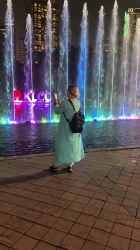 Crowds gather for nighttime fountain show at KLCC Park