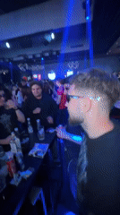 Nightclub patrons gather, dance around drinks table in Plovdiv