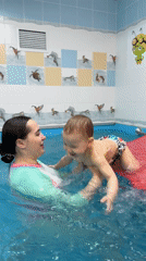 Woman and child enjoy swimming pool time in Zhukovo