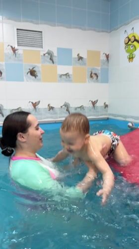 Woman and child enjoy swimming pool time in Zhukovo