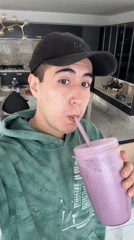 Young man enjoys purple smoothie in Puebla, Mexico