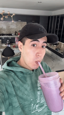 Young man enjoys purple smoothie in Puebla, Mexico