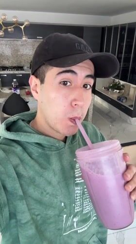 Young man enjoys purple smoothie in Puebla, Mexico