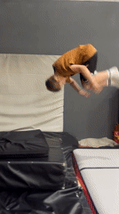 Boys practice gymnastics on inflatable equipment in Krasnoyarsk gym