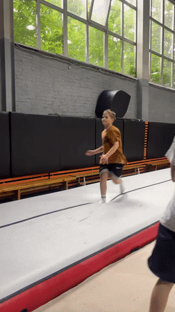Boys practice gymnastics on inflatable equipment in Krasnoyarsk gym