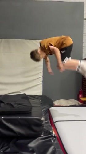 Boys practice gymnastics on inflatable equipment in Krasnoyarsk gym