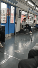 Transit rider documents subway journey, city skyline in Chongqing