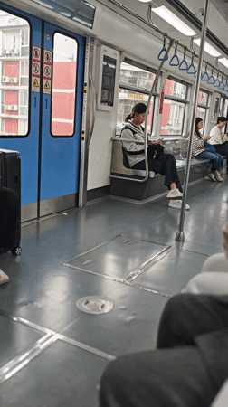Transit rider documents subway journey, city skyline in Chongqing