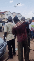 Daytime street scene with pedestrians captured in urban area