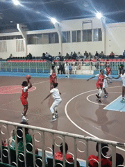 Women's basketball game documented by spectators in Nairobi arena