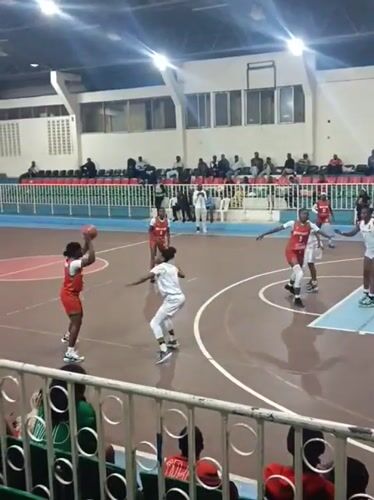 Women's basketball game documented by spectators in Nairobi arena
