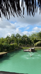 Turquoise pond, tropical greenery, and quirky decor at a Thai retreat