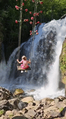 Father and daughter enjoy afternoon at Abkhazia waterfall swings