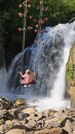 Father and daughter enjoy afternoon at Abkhazia waterfall swings