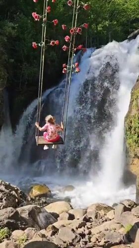 Father and daughter enjoy afternoon at Abkhazia waterfall swings