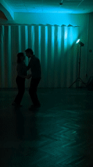Couple shares intimate dance in dimly lit Saint Petersburg room