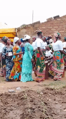 Women gather in traditional dress at Kujama construction site